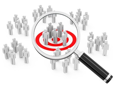 Magnifying glass round small group of people - target market concept