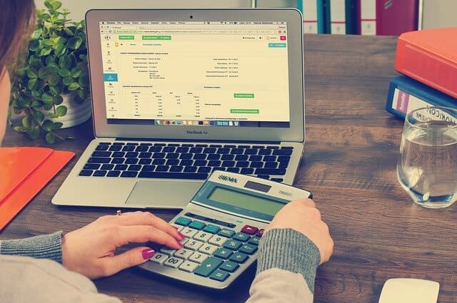 Bookkeeping with laptop and calculator