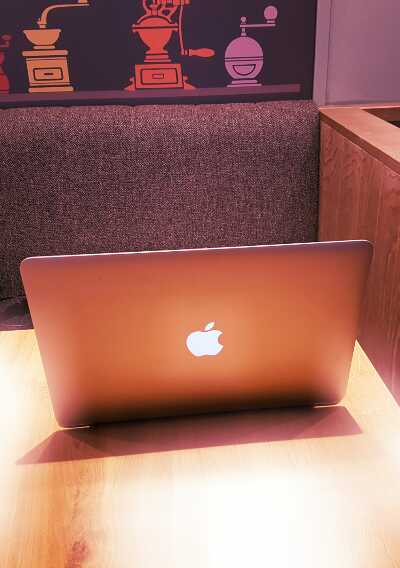 Macbook in cafe, purple filter