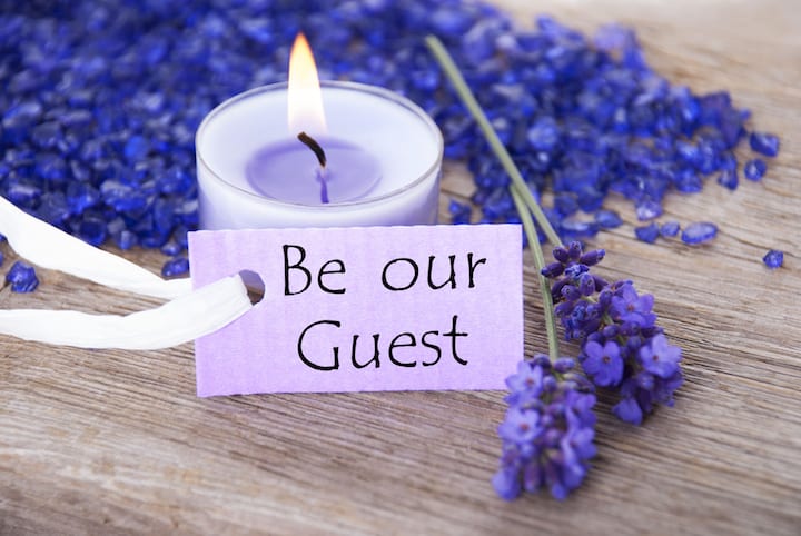Be Our Guest - message on card a purple tag with copy space and a wellness background