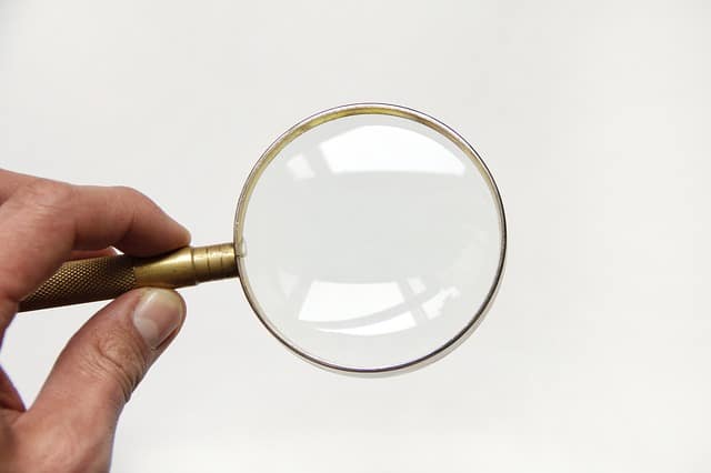 close up of hand held magnifying glass